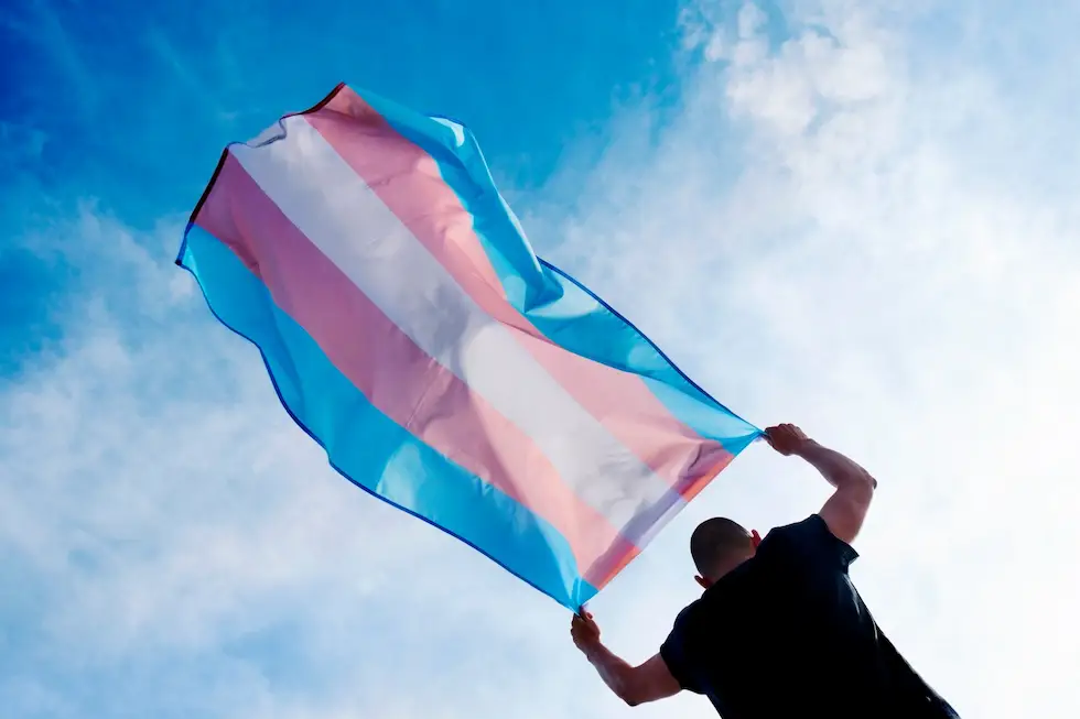 male holding a pride flag